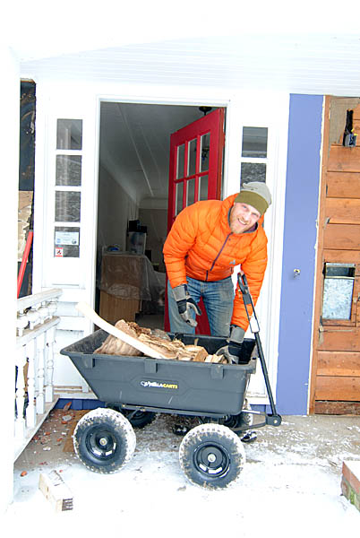 Adam loading firewood into the house. The little dump cart / wagon is a new purchase - perfect for hauling all things around our property!