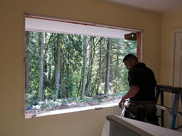 Removing the large window in the guest room.