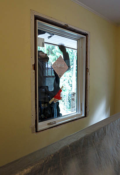 Installing the small window in the guest room.
