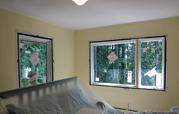 A view of the interior of the guest room with both of the new windows installed. The view of the forest is lovely!