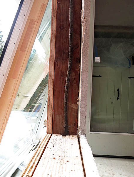 When they pulled the old window out, we found electrical wires running down the jambs of some of the windows. We kept these in place, as they are still being used for outlets.