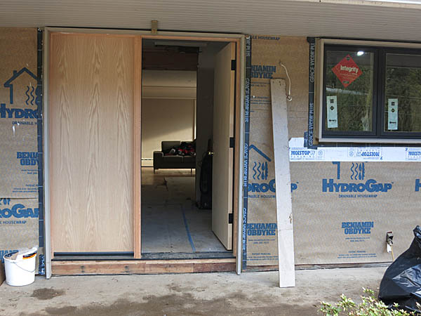 This photo shows the trim 'frame' around the front door. The side pieces of trim will be cut shorter and a bottom piece will be attached to complete the 'frame.' (Remember, the left side of the door will be glass when we get the real door installed).